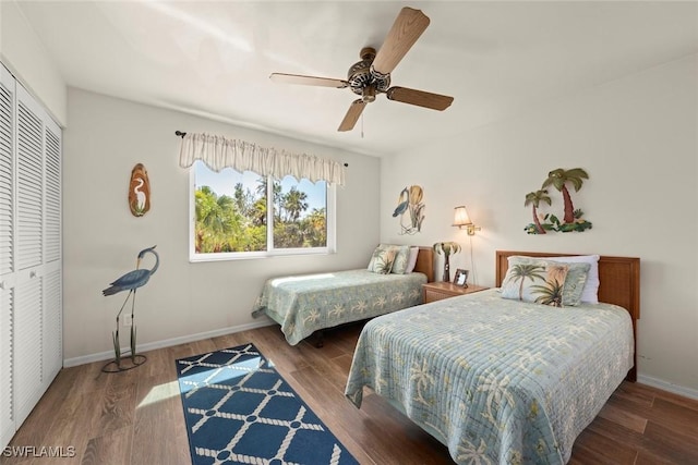 bedroom with ceiling fan, dark hardwood / wood-style flooring, and a closet