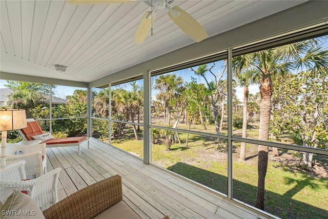 sunroom / solarium featuring ceiling fan