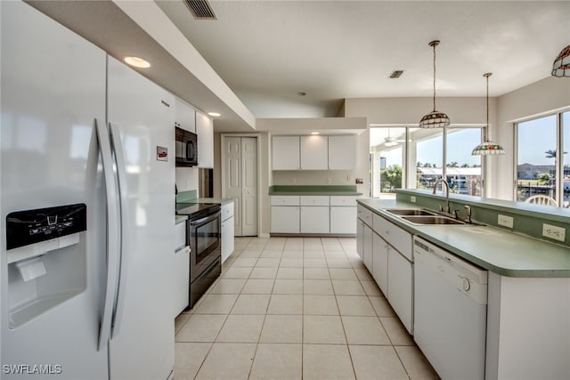 kitchen featuring sink, hanging light fixtures, light tile patterned floors, white appliances, and white cabinets