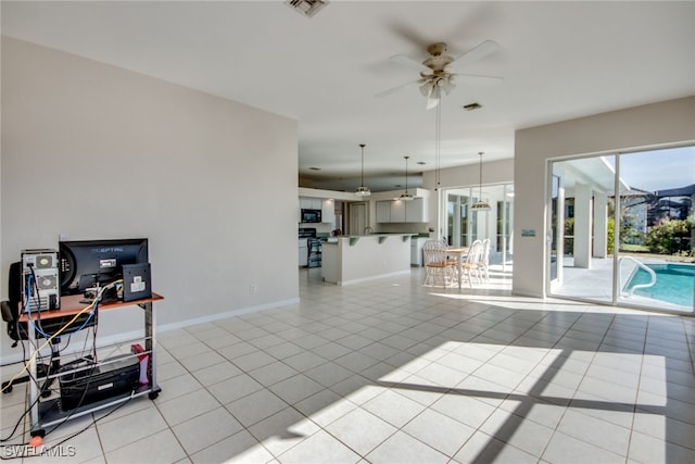 interior space featuring light tile patterned flooring and ceiling fan