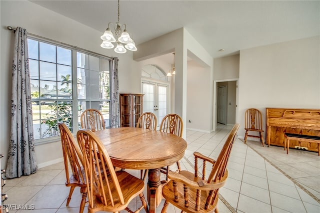 tiled dining area with french doors, a notable chandelier, and a wealth of natural light