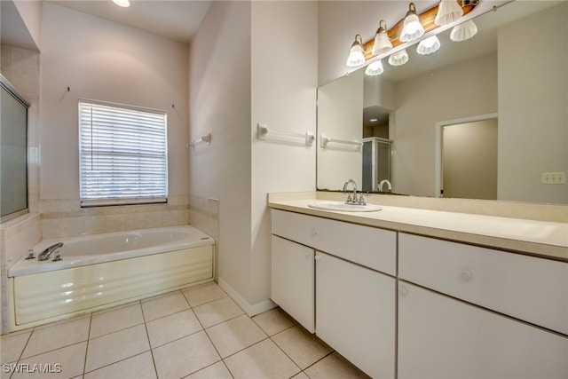 bathroom with vanity, tile patterned floors, and a tub to relax in