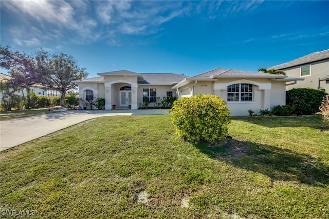 view of front of property with a garage and a front yard