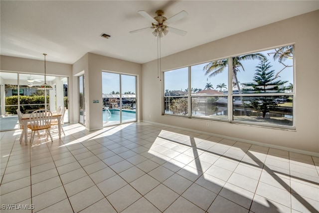 unfurnished room with ceiling fan and light tile patterned floors