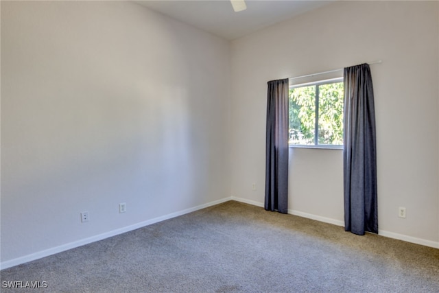 empty room with ceiling fan and light carpet