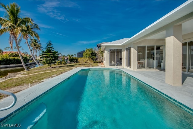 view of pool featuring a patio area and a lawn