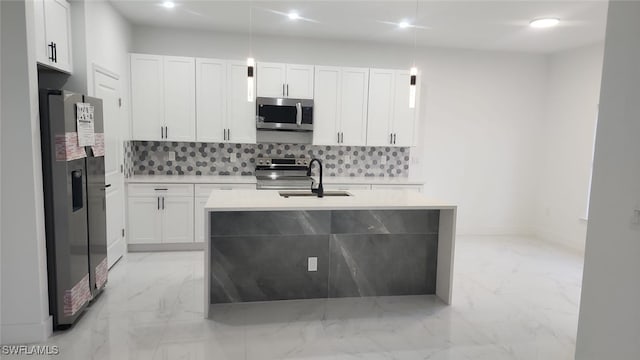 kitchen with a sink, appliances with stainless steel finishes, backsplash, and marble finish floor