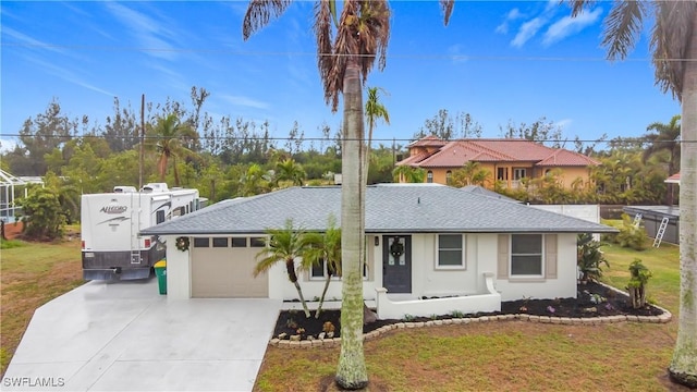 view of front of home with a garage and a front lawn