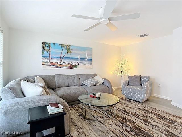 living room featuring hardwood / wood-style flooring and ceiling fan