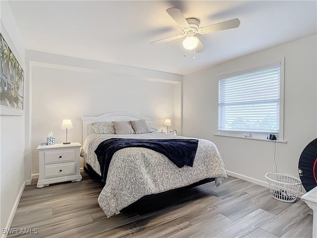 bedroom with light hardwood / wood-style flooring and ceiling fan