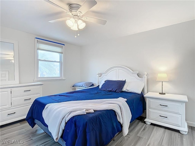 bedroom with light hardwood / wood-style flooring and ceiling fan