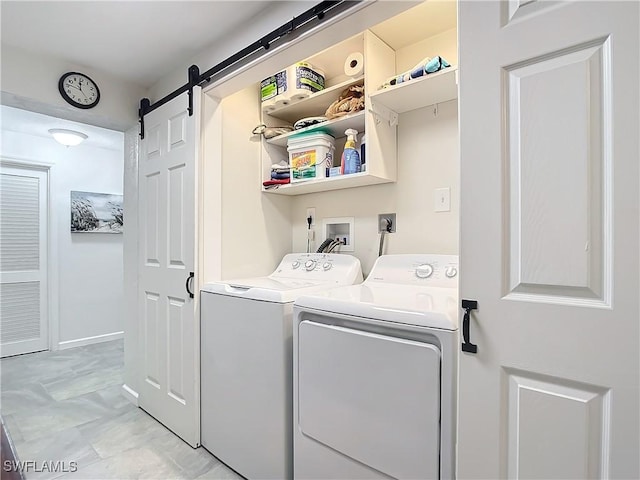 washroom featuring washer and clothes dryer and a barn door