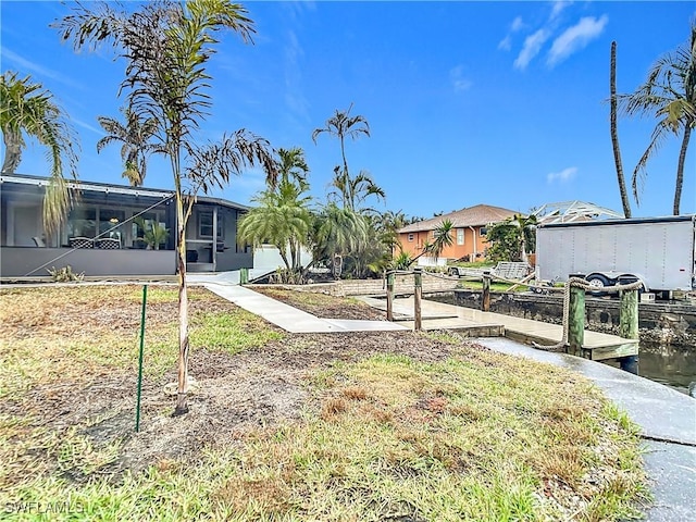 view of yard featuring a water view and a lanai