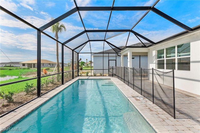 view of pool with a patio and glass enclosure