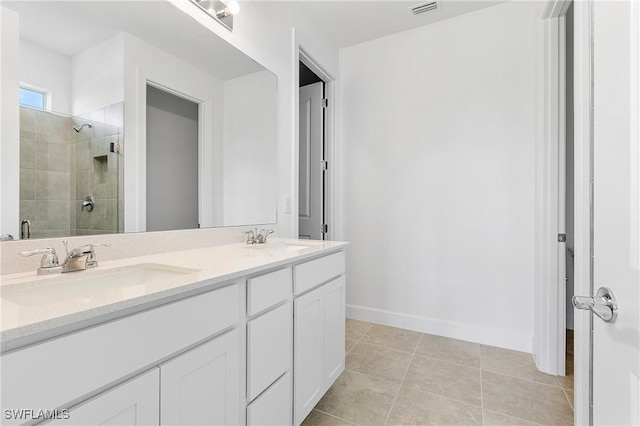 bathroom featuring vanity, tile patterned flooring, and a shower with door