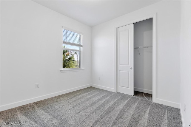 unfurnished bedroom with a closet and carpet