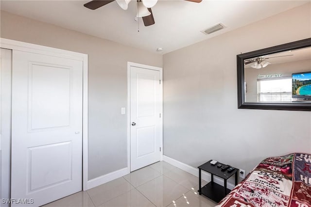 unfurnished bedroom with ceiling fan and light tile patterned floors