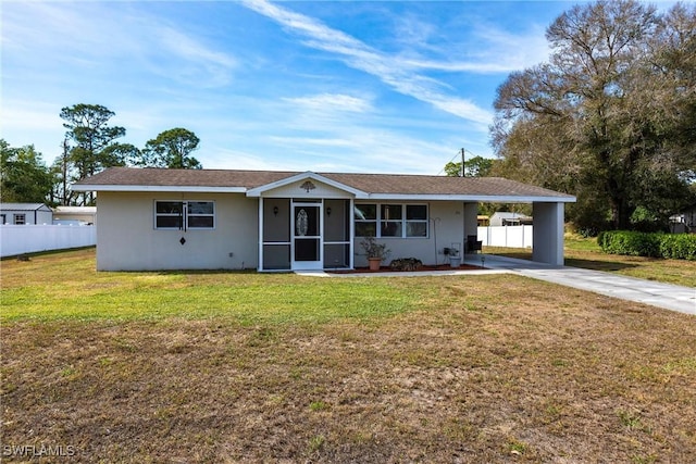 ranch-style home featuring a carport and a front yard