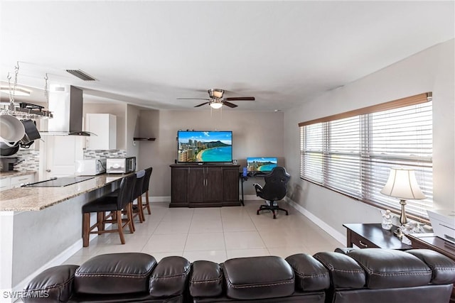 tiled living room featuring ceiling fan