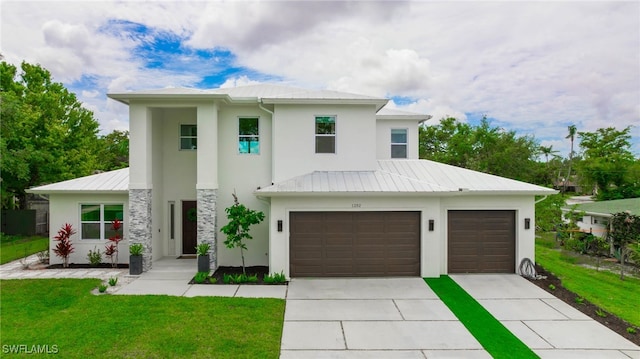 view of front of home with a garage and a front yard