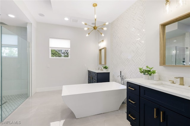 bathroom featuring an inviting chandelier, tile patterned floors, vanity, and separate shower and tub