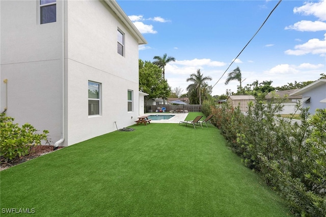 view of yard with a fenced in pool