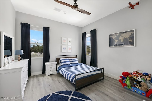 bedroom with light hardwood / wood-style flooring and ceiling fan