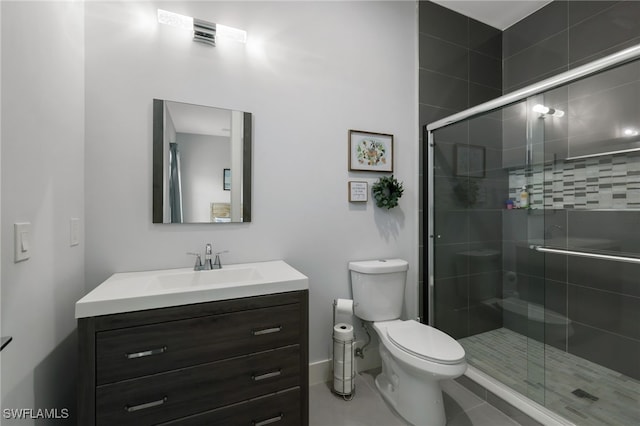 bathroom with vanity, an enclosed shower, and toilet