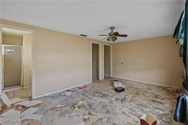 unfurnished living room featuring a textured ceiling and ceiling fan