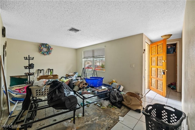 interior space with light tile patterned flooring and a textured ceiling