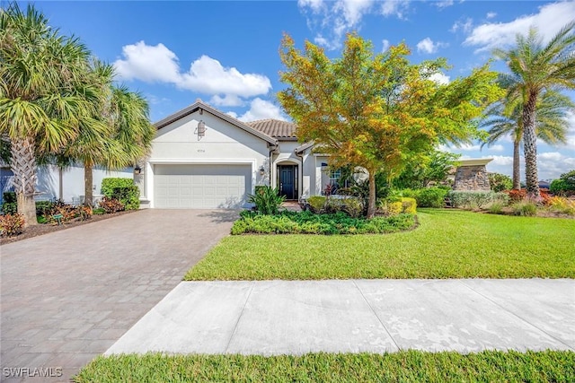 view of front of property with a garage and a front lawn