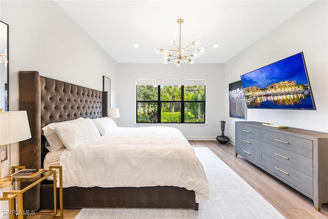 bedroom featuring a chandelier and light hardwood / wood-style floors