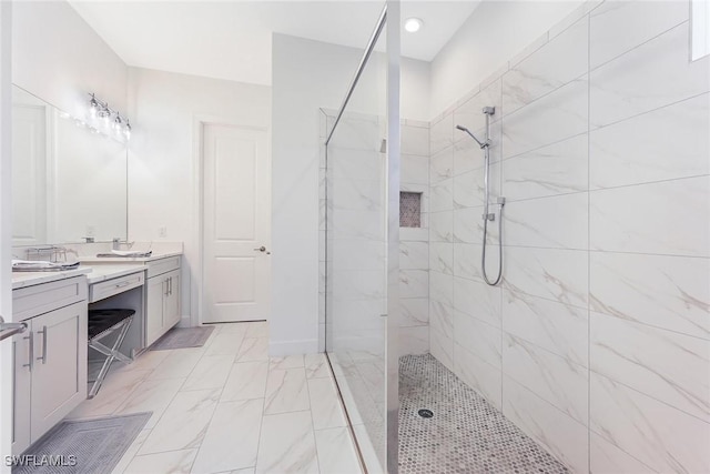 bathroom featuring vanity and tiled shower