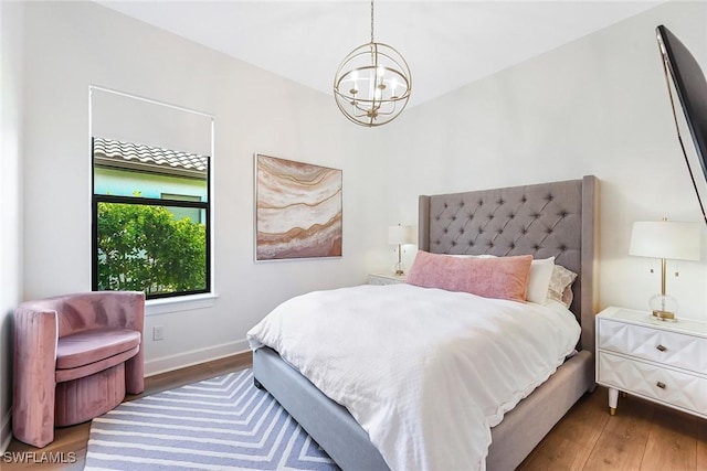 bedroom featuring an inviting chandelier and dark hardwood / wood-style floors