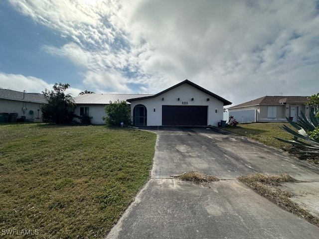 single story home with a garage and a front yard