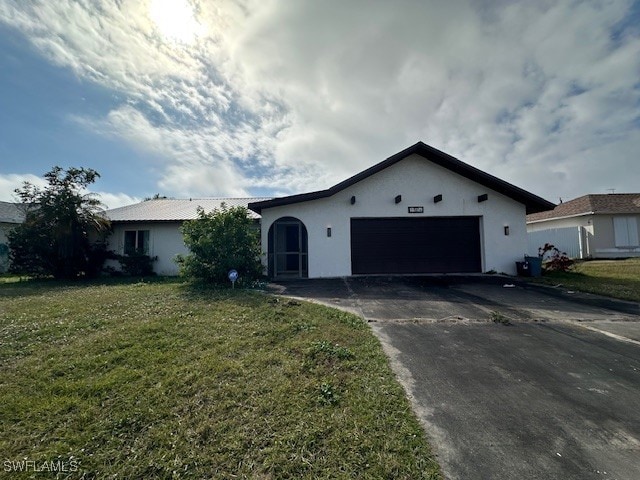 single story home with a garage and a front yard