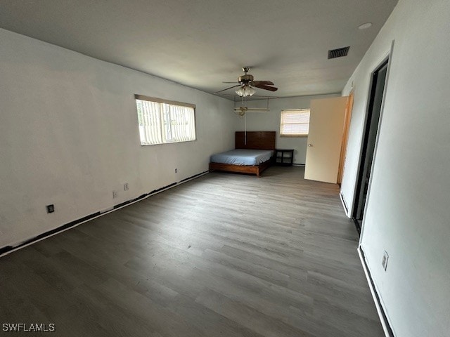 unfurnished bedroom featuring wood-type flooring and ceiling fan