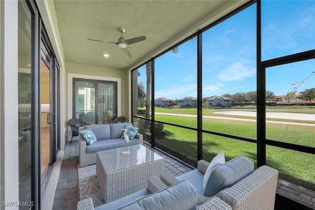 sunroom / solarium featuring a wealth of natural light and ceiling fan