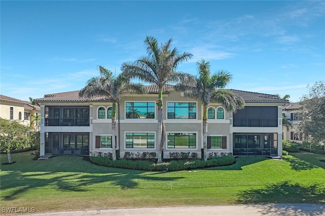 back of property featuring a lawn