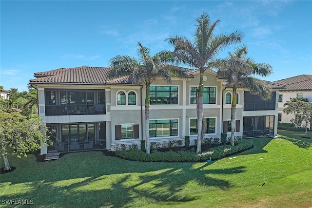 rear view of property featuring a lawn