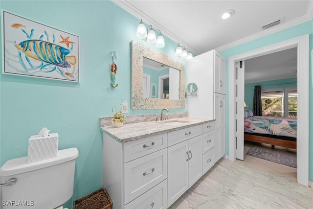 bathroom with vanity, crown molding, and toilet