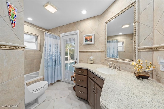 full bathroom featuring tile walls, tile patterned flooring, vanity, toilet, and shower / bath combo