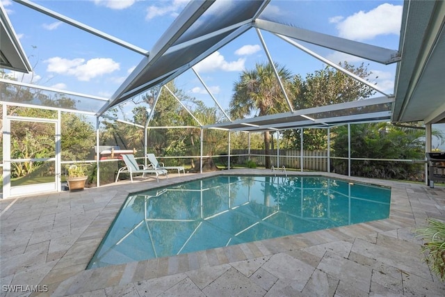 view of swimming pool with a patio area and glass enclosure