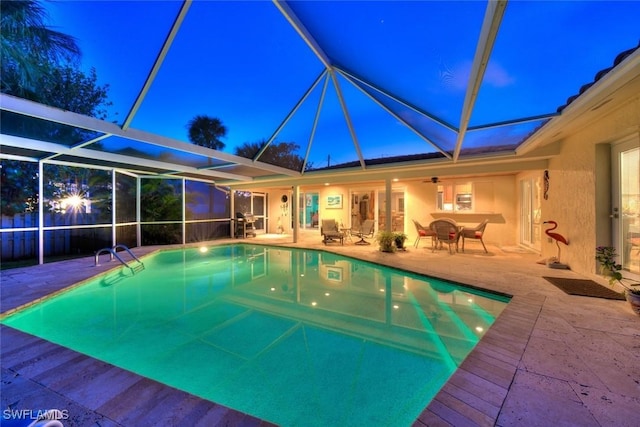 view of pool with a lanai, ceiling fan, and a patio area