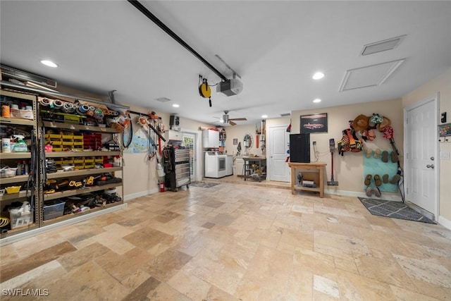 garage with a garage door opener and washer and clothes dryer