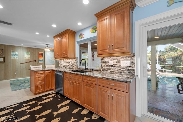 kitchen featuring sink, stainless steel dishwasher, backsplash, and kitchen peninsula