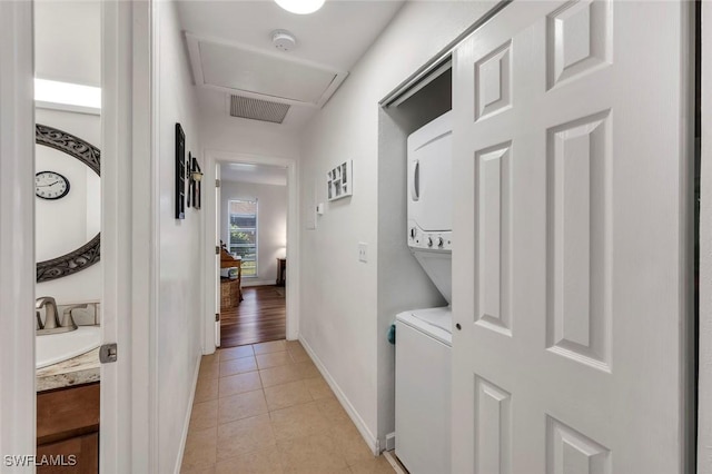 hall featuring light tile patterned flooring and sink