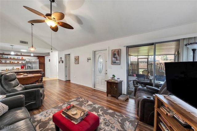 living room with lofted ceiling, dark hardwood / wood-style floors, and ceiling fan