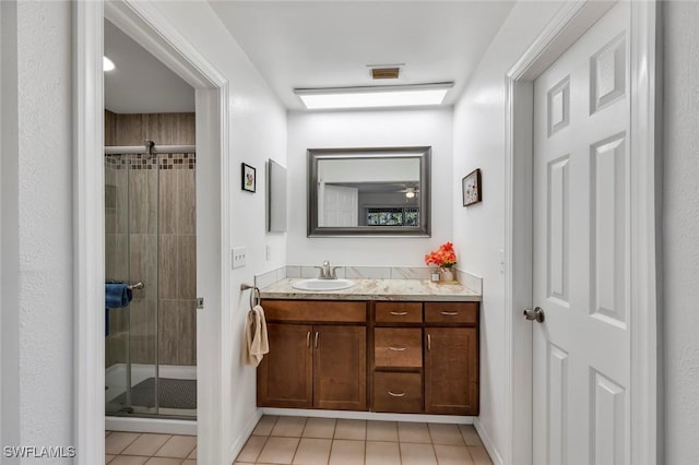 bathroom featuring vanity, tile patterned floors, and walk in shower