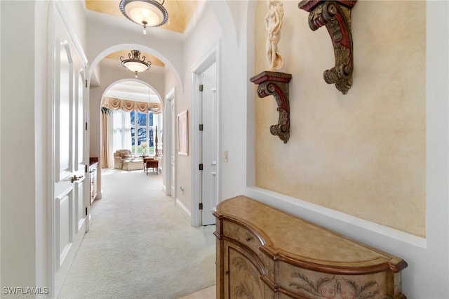 hallway with light colored carpet